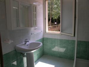 Un baño con lavabo y ventana. en Apts. Serena by SolturElba, en Capoliveri 93 fotos más