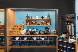 a kitchen with a shelf filled with food at D8 Hotel in Budapest