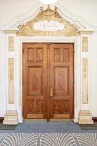 a large wooden door with a sign on it at Fraser Suites Hamburg in Hamburg