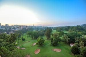 an overhead view of a golf course with trees and rocks at BMK House Apartments in Kampala