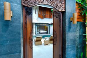 a door leading into a room with a living room at La Paradis Villa in Canggu