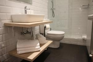a bathroom with a sink and a toilet and a shower at Casa Rural Iruso in Leitza
