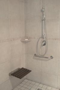 a shower with a wooden seat in a bathroom at Dolliwarie Guesthouse in Panorama