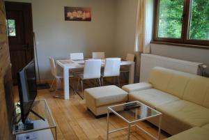 a living room with a couch and a table with chairs at Gite chez Phil in Durbuy
