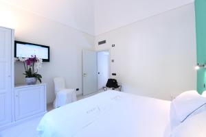 Ένα ή περισσότερα κρεβάτια σε δωμάτιο στο Villa Lara Hotel