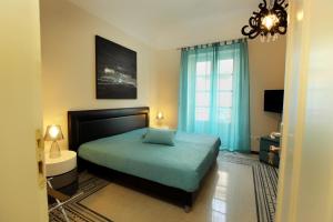 a bedroom with a large bed and a large window at Abatellis Luxury in Palermo