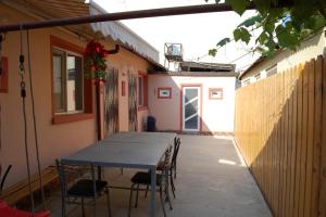 a patio with a table and chairs in a house at Casa cu Castan in Eforie Nord