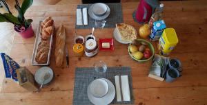 a table with food and bread and drinks on it at La maison des dentelliers in Calais