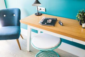 a desk with a chair and a book on it at Hotel Almirante in Alicante