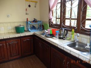 a kitchen with a sink and a counter top at Mount View Family Rest & Cottage in Haputale