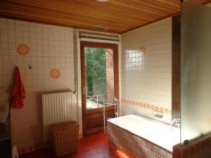 a bathroom with a bath tub and a window at Green Hill Apartment Overijse in Overijse +26 photos