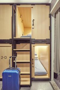 a room with a bunk bed and a suitcase at THE CAPSULE Myeongdong in Seoul