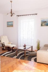 a living room with a coffee table and a couch at Apartment Sv. Marak in Risika