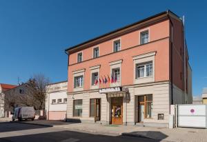 a large brick building on the corner of a street at Penzion Fan in Karlovy Vary