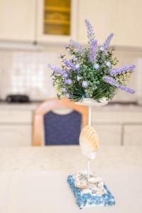a vase of purple flowers sitting on top of a table at Apartment Sv. Marak in Risika