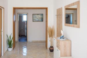 a hallway with a door leading into a room at Apartment Sv. Marak in Risika