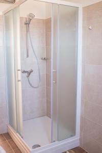 a shower with a glass enclosure in a bathroom at Apartment Sv. Marak in Risika +25 photos