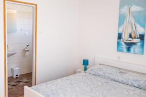 a bedroom with a bed and a painting on the wall at Apartment Sv. Marak in Risika