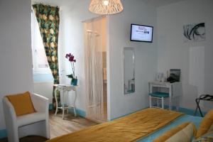ein Schlafzimmer mit einem Bett, einem Stuhl und einem Fenster in der Unterkunft Ferme de Lagrave in Coux-et-Bigaroque