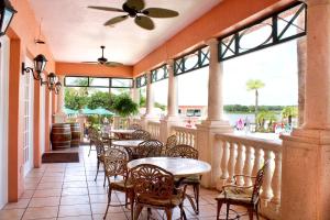 an outdoor patio with tables and chairs and windows at Summer Bay Orlando by Exploria Resorts in Orlando