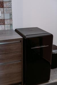 a black microwave oven sitting next to a counter at JAM Luxury Apartment in Győr