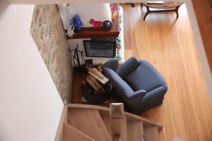 an overhead view of a living room with a blue couch at Alkioni stone house in Hydra