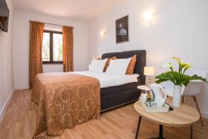 a hotel room with a bed and a table at Villa Dard in Dubrovnik