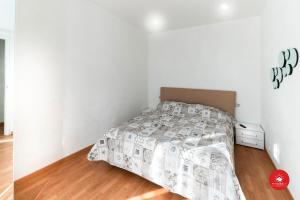 ein weißes Schlafzimmer mit einem Bett und einer Kommode in der Unterkunft 36 Holidays Home in La Spezia