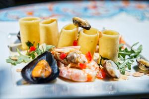 a plate of food with shrimp and mussels on it at Grand Hotel Il Ninfeo in Gaeta