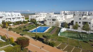 an apartment complex with a swimming pool and buildings at Apart.conil-vistasol in Conil de la Frontera