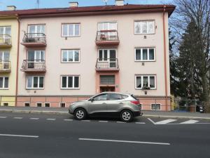 a silver car parked in front of a building at Apartmány Monty in Karlovy Vary