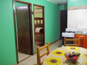 a kitchen with a table with a bowl of fruit on it at Cabañas El Hornero in Puerto Iguazú