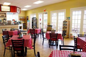 a kitchen filled with tables and chairs and chairs at Summer Bay Orlando by Exploria Resorts in Orlando
