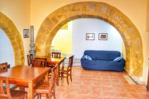 a living room with a blue couch and tables at B&B Anita in Agrigento