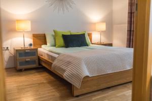 a bedroom with a bed with two night stands and two lamps at Colours Apartments Budapest in Budapest