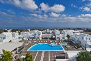 a large blue and white building with a swimming pool at El Greco Resort & Spa in Fira