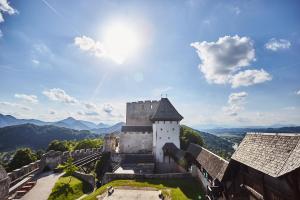 an old castle with mountains in the background at Rooms Reaktiv in Zreče +43 photos