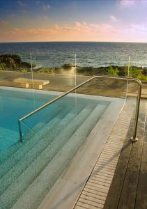 a swimming pool with a view of the ocean at Hotel Ereza Mar - Adults Only in Caleta De Fuste