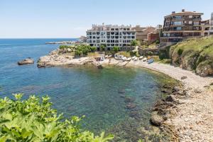a view of a beach with buildings and the ocean at Apartment Nerea in L'Escala
