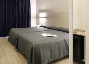 Postel nebo postele na pokoji v ubytování Hotel Brasil