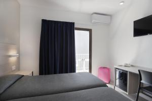 Postel nebo postele na pokoji v ubytování Hotel Brasil