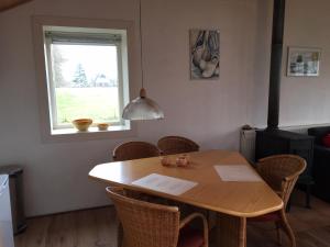 a dining room table with chairs and a window at The Old Barn in Hoevelaken