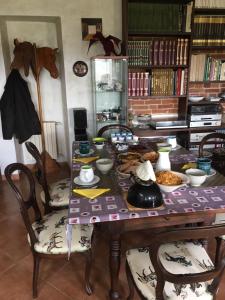 a table with food on it in a room at B&B Cascina Dei Levrieri in Capriglio