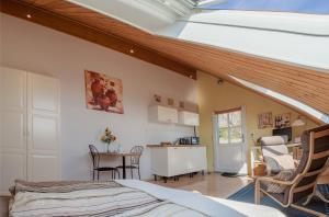 a bedroom with a skylight and a room with a bed at Domaine Beauregard in Rolle