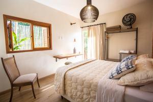 Postel nebo postele na pokoji v ubytování Vilarejo Guesthouse - Silêncio e Aconchego
