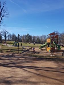 a park with a playground with people playing in it at Nid douillet au centre ville in Épinal