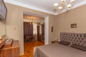 a bedroom with a bed and a living room at Azneft Square Flame Towers View Apartment in Baku
