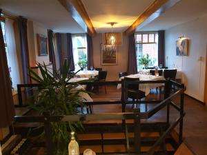 a dining room with tables and chairs in a restaurant at Herberg restaurant Molenrij in Kloosterburen