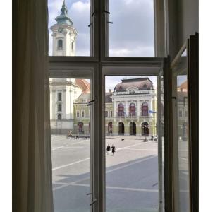 an open window with a view of a large building at Anna Apartman in Eger