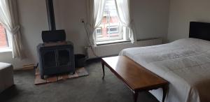 1 dormitorio con 1 cama y fogones en una habitación en Herberg restaurant Molenrij, en Kloosterburen